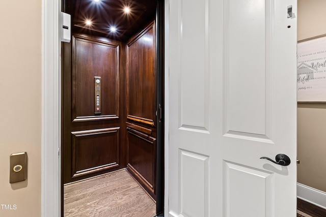 room details featuring hardwood / wood-style floors and elevator