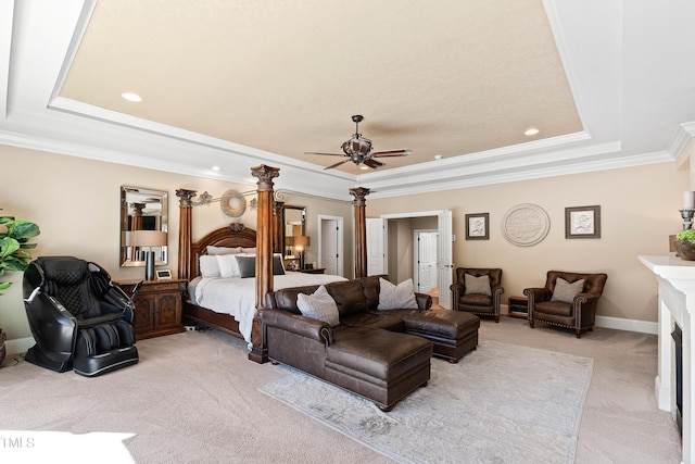 carpeted bedroom with ornamental molding, ceiling fan, and a raised ceiling