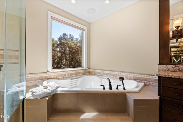 bathroom with independent shower and bath, vanity, and tile patterned floors