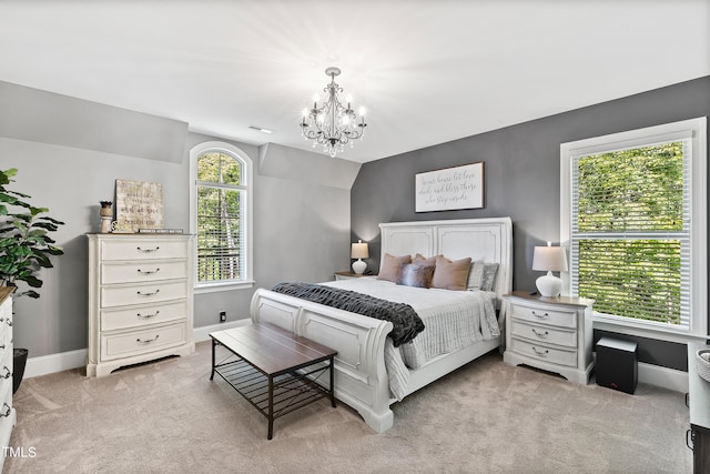 bedroom featuring an inviting chandelier and light colored carpet