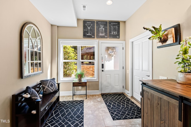 doorway to outside featuring light tile patterned floors