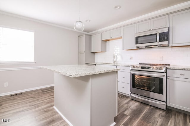 kitchen with gray cabinetry, a center island, decorative light fixtures, and stainless steel appliances