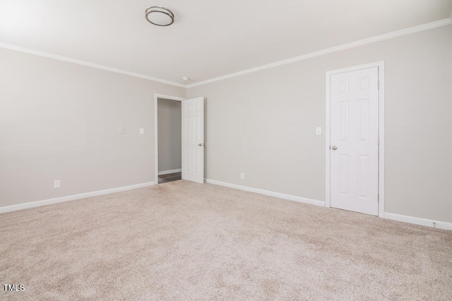 unfurnished room with ornamental molding and carpet flooring