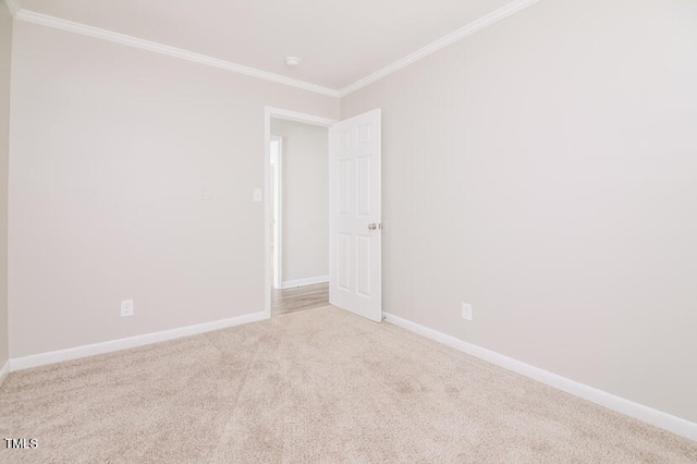 carpeted spare room with ornamental molding