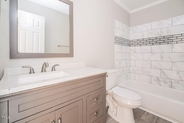 full bathroom with ornamental molding, hardwood / wood-style floors, toilet, vanity, and tiled shower / bath combo