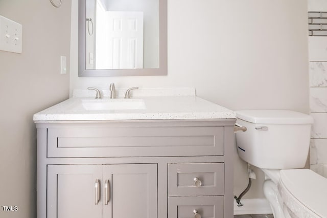 bathroom with toilet and vanity