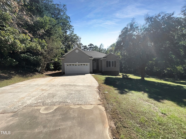 view of front of home with a garage and a front lawn