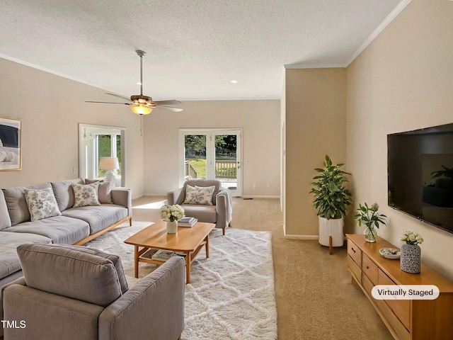 living room with light carpet, crown molding, ceiling fan, and a textured ceiling