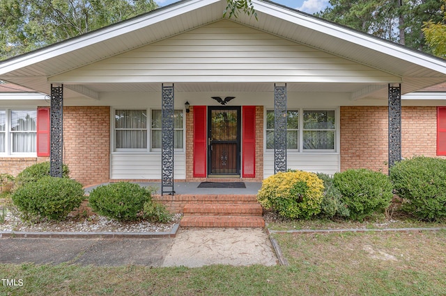 view of front of house with covered porch and brick siding