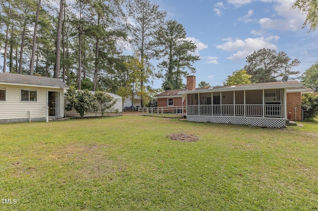 view of yard featuring a sunroom and fence