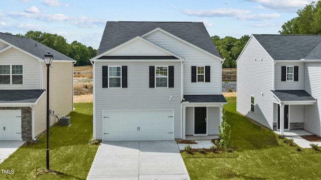 front of property featuring central AC unit, a front yard, and a garage