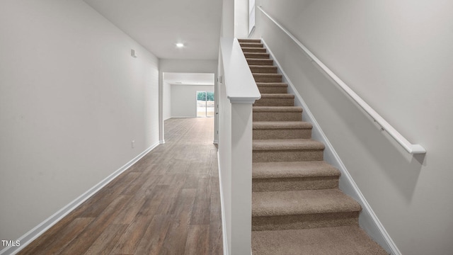 stairway with hardwood / wood-style floors