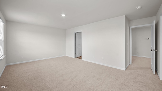 unfurnished bedroom featuring light carpet