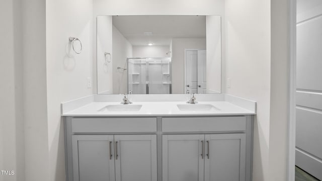 bathroom featuring vanity and an enclosed shower