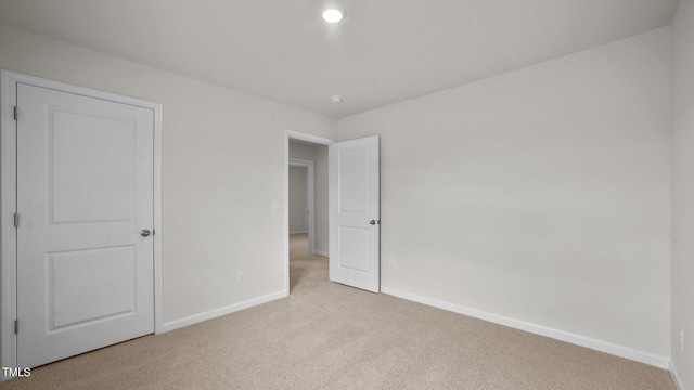 unfurnished bedroom with light colored carpet