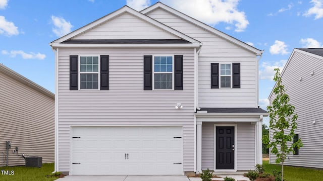 front of property featuring cooling unit and a garage