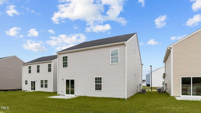 back of house featuring a lawn, a patio area, and central AC