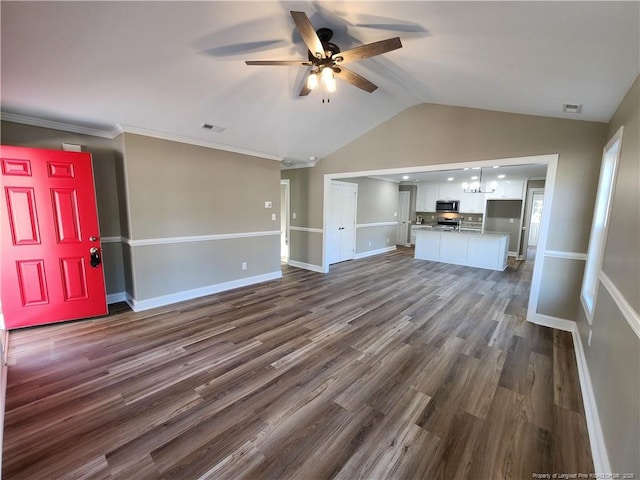 unfurnished living room with ceiling fan with notable chandelier, dark hardwood / wood-style flooring, lofted ceiling, and crown molding