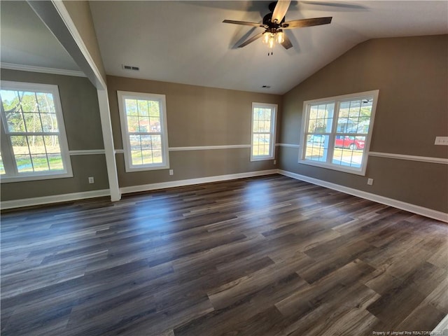 spare room with ceiling fan, a healthy amount of sunlight, dark wood-type flooring, and vaulted ceiling