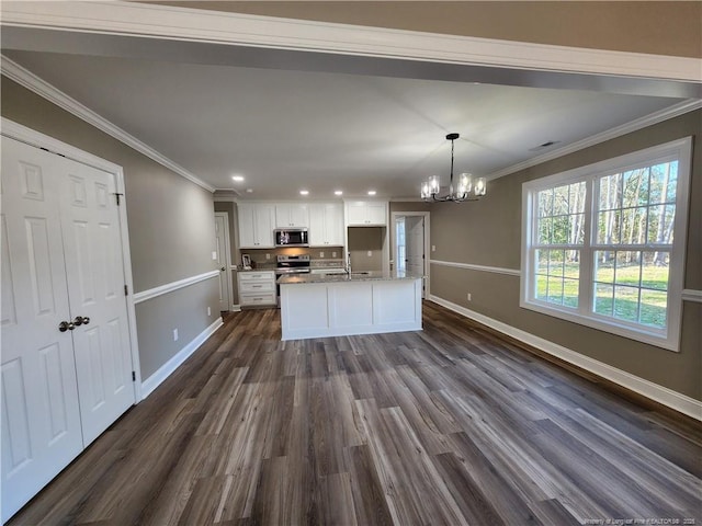 kitchen featuring dark hardwood / wood-style flooring, stainless steel appliances, an inviting chandelier, white cabinetry, and hanging light fixtures