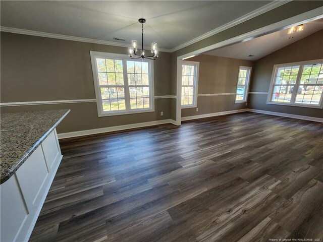 unfurnished dining area with a chandelier, vaulted ceiling, plenty of natural light, and dark wood-type flooring