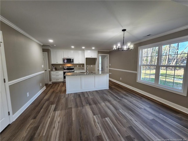 kitchen with dark wood-type flooring, sink, appliances with stainless steel finishes, white cabinetry, and a chandelier