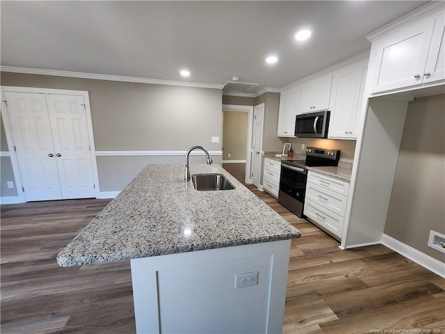 kitchen featuring sink, stainless steel appliances, light stone counters, a kitchen island with sink, and white cabinets