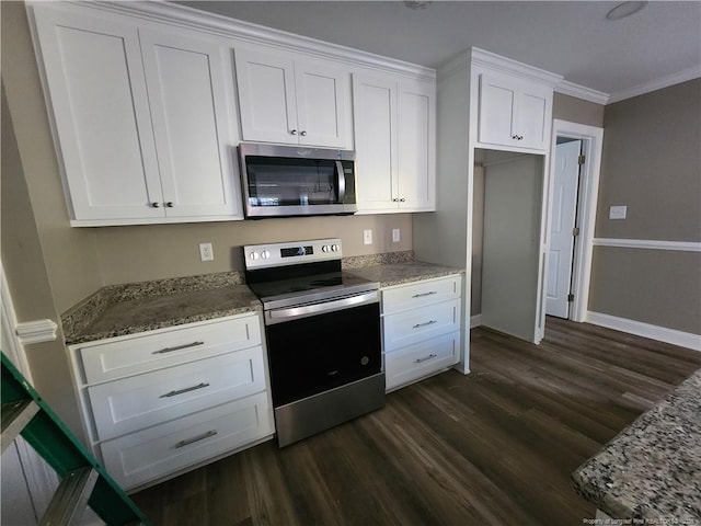 kitchen with white cabinetry, stainless steel appliances, dark hardwood / wood-style flooring, dark stone counters, and ornamental molding