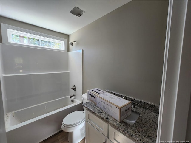 full bathroom with bathing tub / shower combination, vanity, wood-type flooring, and toilet