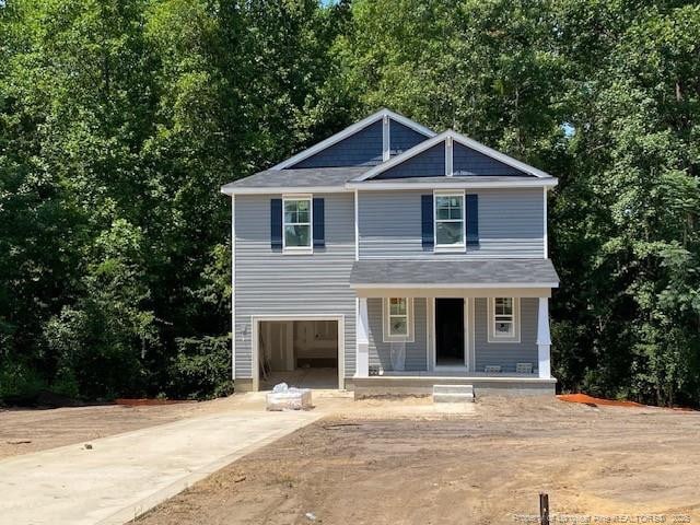 view of front of home featuring covered porch and a garage