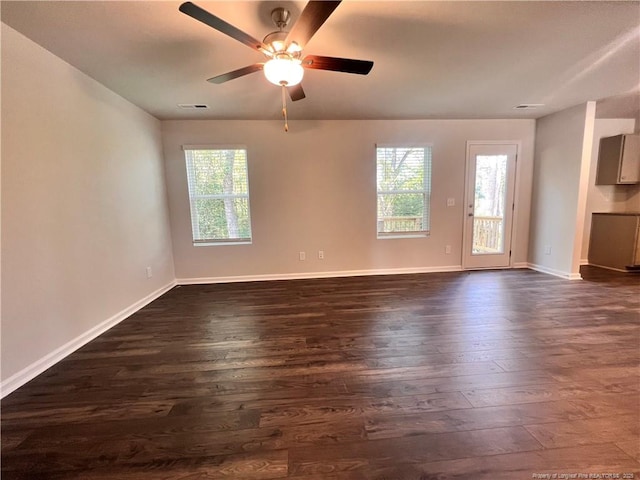 spare room with dark hardwood / wood-style floors and ceiling fan