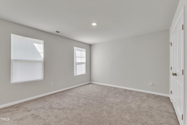 unfurnished room featuring light colored carpet