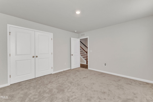 unfurnished bedroom featuring a closet and carpet flooring