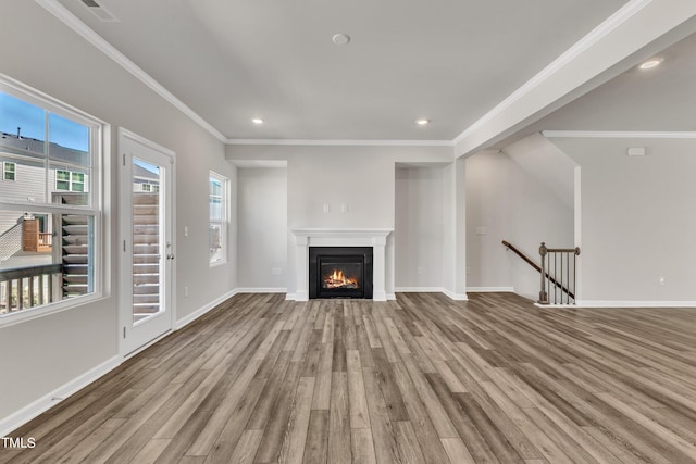 unfurnished living room with crown molding and light hardwood / wood-style flooring