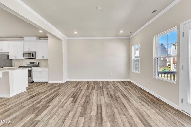 unfurnished living room featuring light hardwood / wood-style flooring and ornamental molding