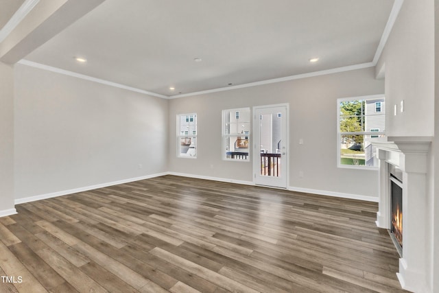 unfurnished living room featuring crown molding and hardwood / wood-style floors