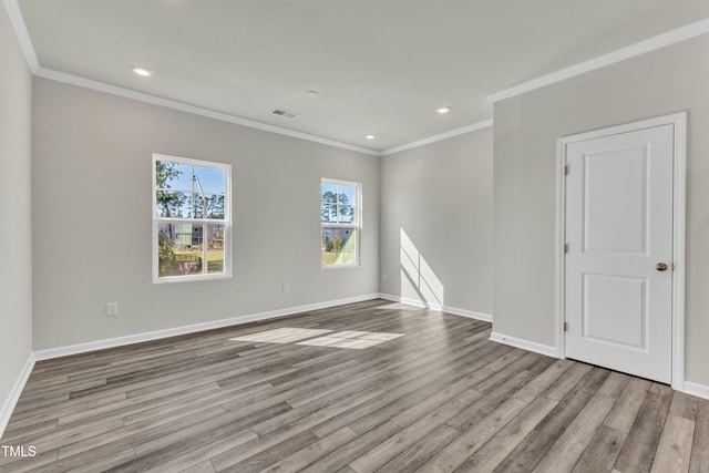 unfurnished room featuring ornamental molding and light wood-type flooring