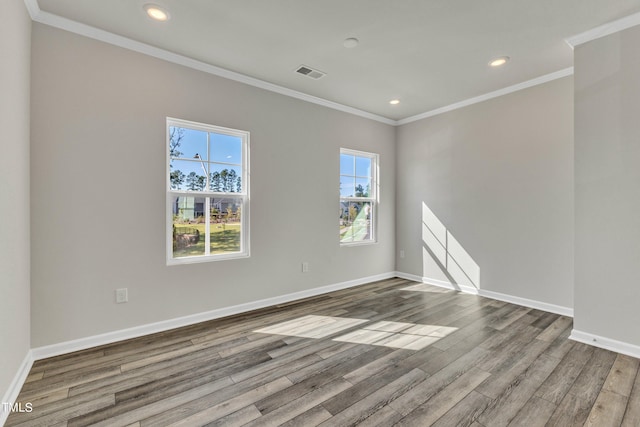 unfurnished room with hardwood / wood-style flooring and ornamental molding