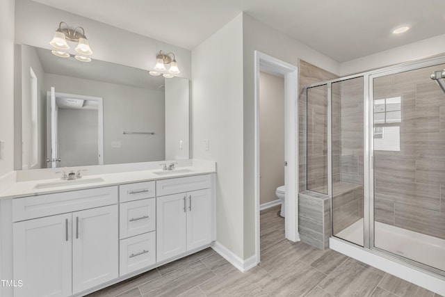 bathroom with vanity, a chandelier, toilet, and walk in shower