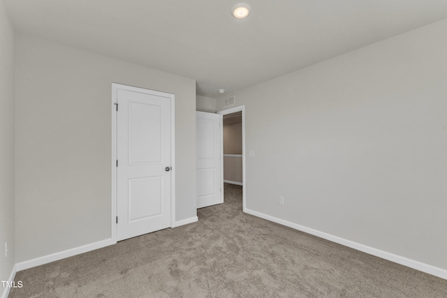 unfurnished bedroom with light colored carpet