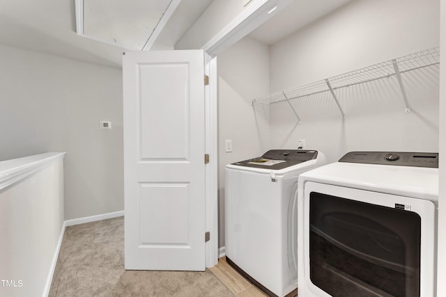 washroom with light colored carpet and washing machine and clothes dryer