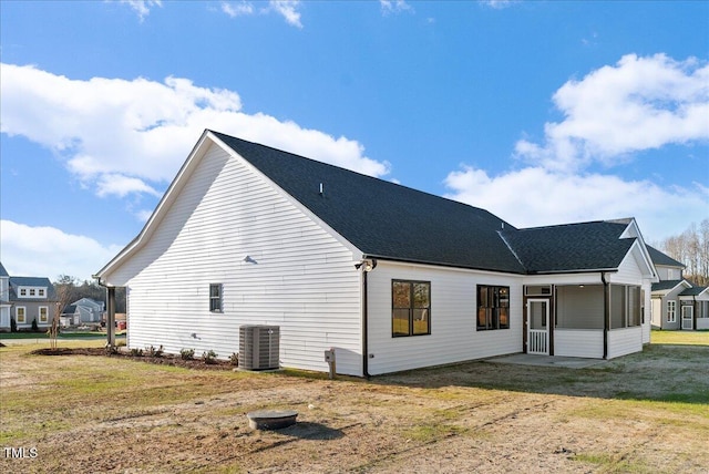 back of house featuring a yard and cooling unit