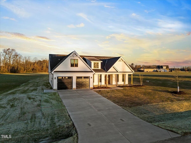 view of front of house with a garage and a lawn