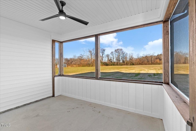 unfurnished sunroom featuring ceiling fan