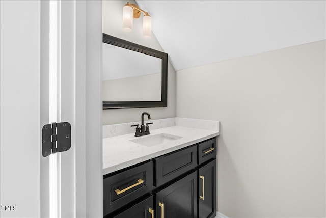 bathroom featuring vanity and lofted ceiling