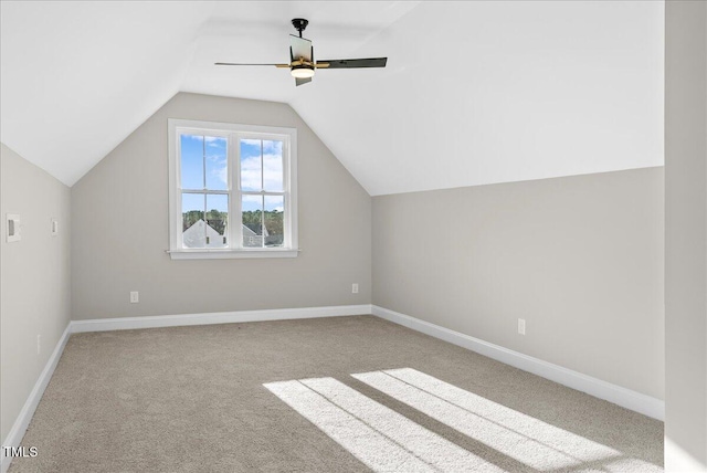 bonus room featuring ceiling fan, light carpet, and vaulted ceiling