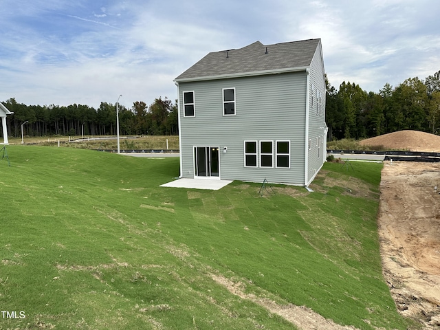 back of house with a patio and a yard