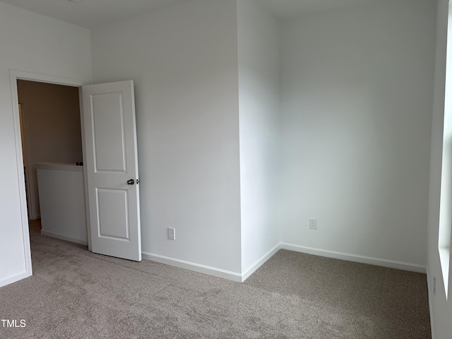 unfurnished room featuring light colored carpet