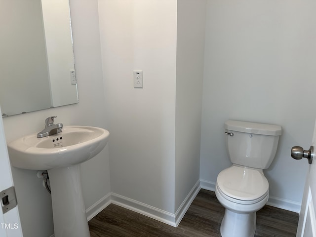 bathroom with wood-type flooring and toilet