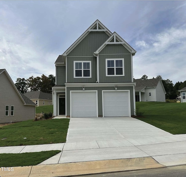 craftsman inspired home featuring a garage, a front lawn, board and batten siding, and concrete driveway